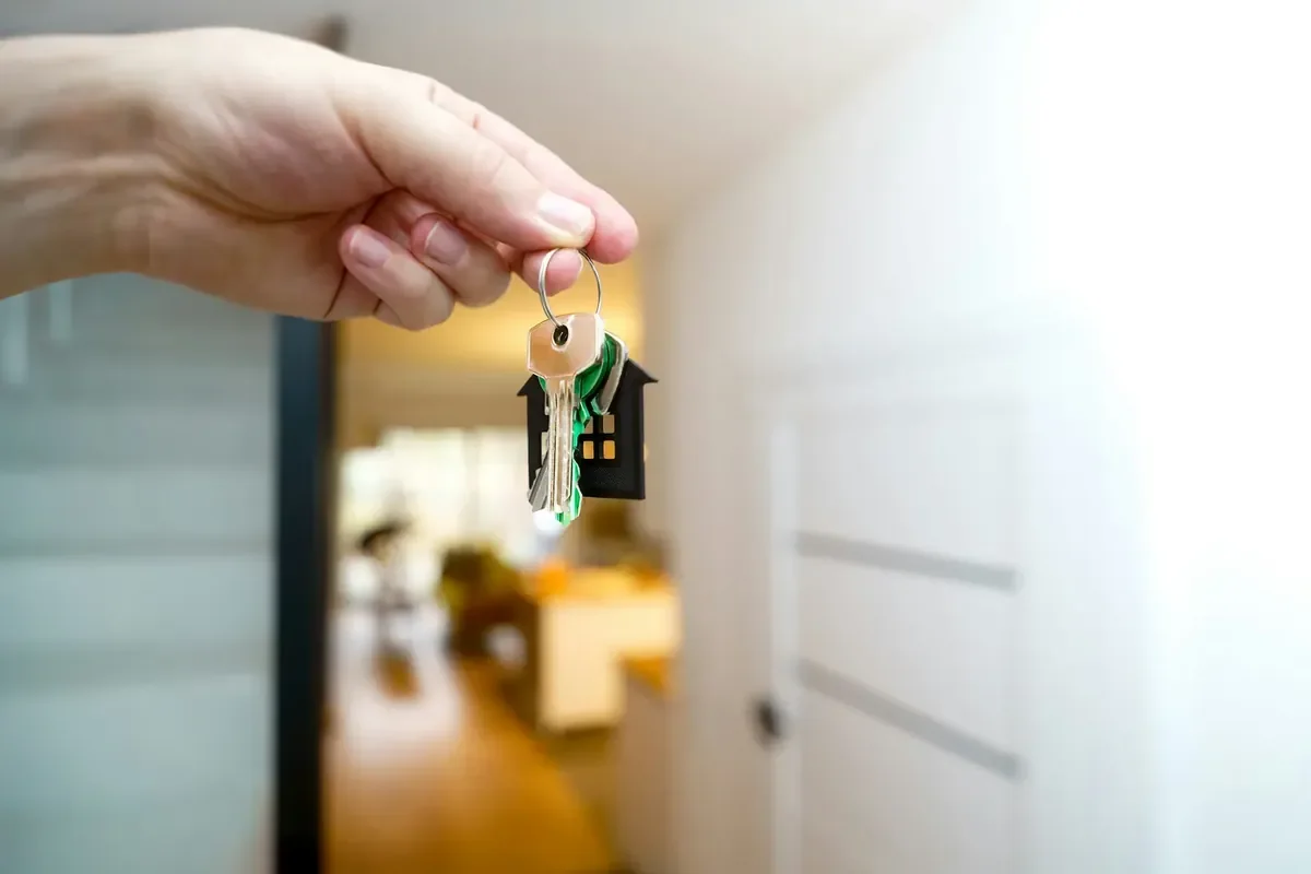 Hand holding the key to a new home