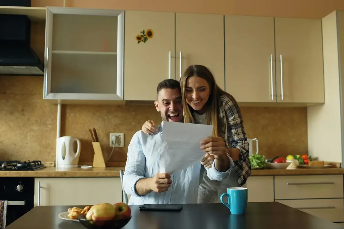 Couple reviewing a document at the kitchen table
