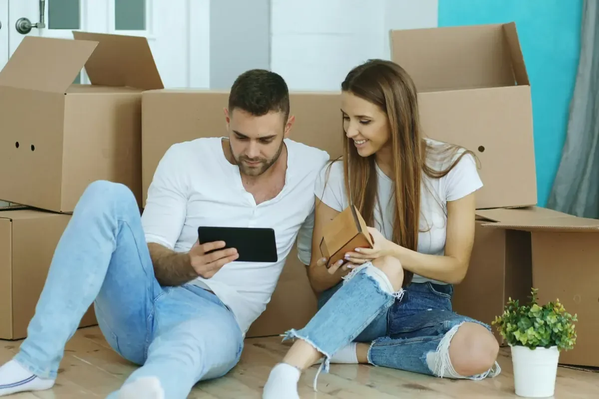 Couple planning a move with a tablet